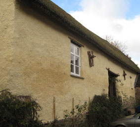 limewashed lime render on traditional thatched barn